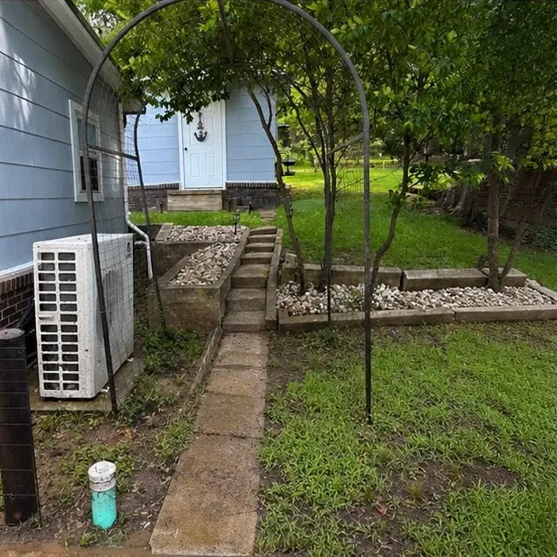 A concrete walk and steps beside a blue-sided house before washing, dull and grey