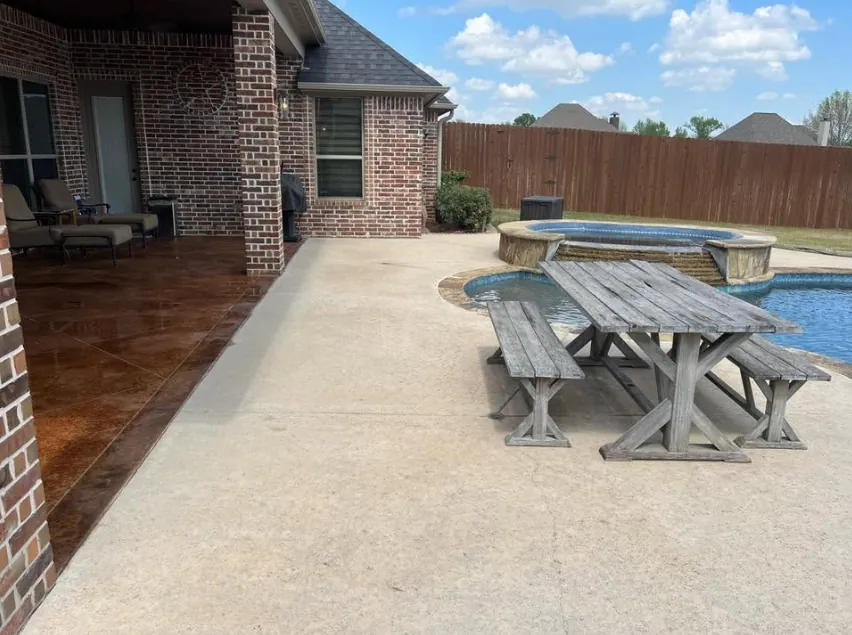 The same pool deck after washing, bright even concrete under a blue sky